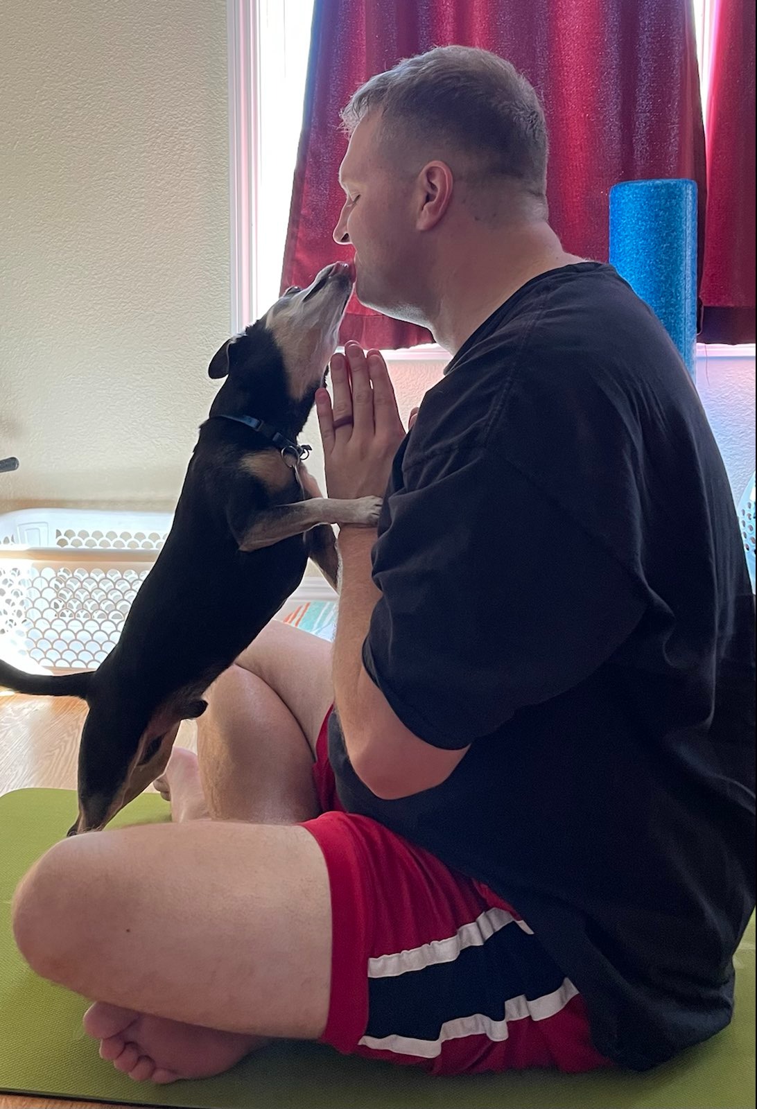 sitting cross legged at the end of yoga class with my dog jackson